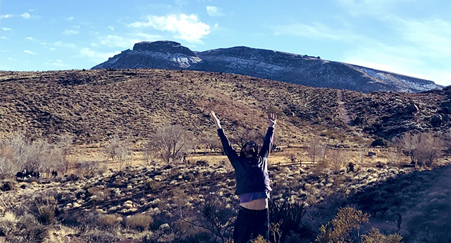 posed arms up in the air red rock canyon mountains beautiful blue sky blessed thank you God 